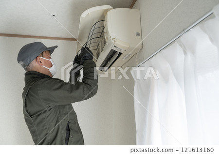 House cleaning male worker cleaning the air conditioner House cleaning male worker cleaning the air conditioner 121613160