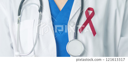 Doctor with Burgundy Red Ribbon for March multiple myeloma Cancer and December World Aids Day Awareness month. Healthcare and world cancer day concept 121613317