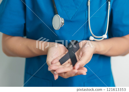 Melanoma and skin cancer, Vaccine injury awareness month and rest in peace concepts. doctor holding black Ribbon Melanoma and skin cancer, Vaccine injury awareness month and rest in peace concepts. doctor holding black Ribbon 121613353