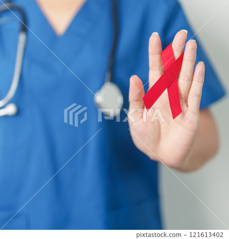 Doctor with Red Ribbon for December World Aids Day, acquired immune deficiency syndrome, multiple myeloma Cancer Awareness month and National Red ribbon week. Healthcare and world cancer day concept 121613402