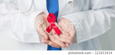 Doctor with Red Ribbon for December World Aids Day, acquired immune deficiency syndrome, multiple myeloma Cancer Awareness month and National Red ribbon week. Healthcare and world cancer day concept 121613414