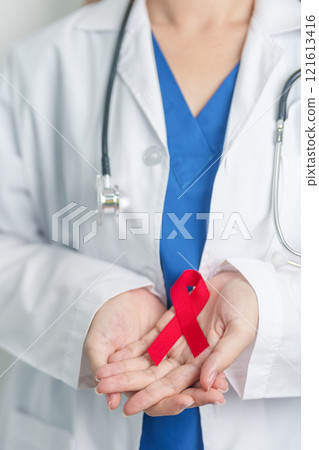Doctor with Red Ribbon for December World Aids Day, acquired immune deficiency syndrome, multiple myeloma Cancer Awareness month and National Red ribbon week. Healthcare and world cancer day concept 121613416