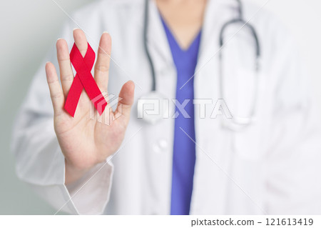 Doctor with Red Ribbon for December World Aids Day, acquired immune deficiency syndrome, multiple myeloma Cancer Awareness month and National Red ribbon week. Healthcare and world cancer day concept 121613419