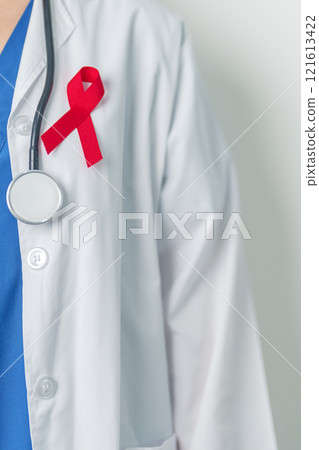 Doctor with Red Ribbon for December World Aids Day, acquired immune deficiency syndrome, multiple myeloma Cancer Awareness month and National Red ribbon week. Healthcare and world cancer day concept Doctor with Red Ribbon for December World Aids Day, acquired immune deficiency syndrome, multiple myeloma Cancer Awareness month and National Red ribbon week. Healthcare and world cancer day concept 121613422