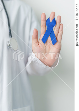 March Colorectal Cancer Awareness month, doctor with dark Blue Ribbon for supporting people living and illness. Healthcare, hope and World cancer day concept 121613433