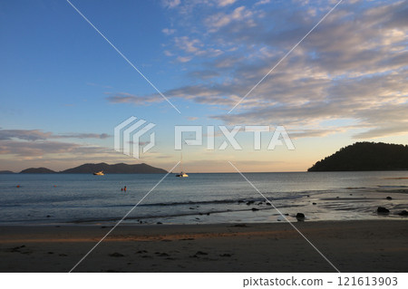 Sailing ship and Ko Khlum, small island at sunset view from Klong Kloi Beach, Ko Chang, Thailand. 121613903