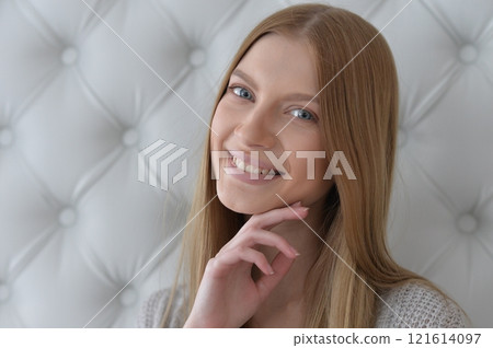 Beauty portrait. Young woman on grey wall background. Beauty portrait. Young woman on grey wall background. 121614097