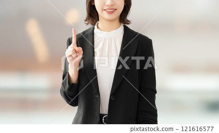 A young woman/businesswoman pointing with her index finger up 121616577