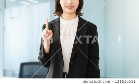 A young woman/businesswoman pointing with her index finger up 121616581