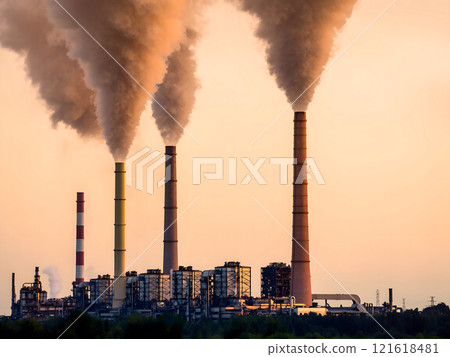 Industrial power plant emitting smoke and steam against a soft, peach-colored sunset sky. Concept of air pollution, fossil fuels, climate change, and environmental impact. Industrial power plant emitting smoke and steam against a soft, peach-colored sunset sky. Concept of air pollution, fossil fuels, climate change, and environmental impact. 121618481