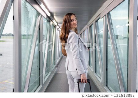 Businesswoman boarding the plane with carry-on 121618892