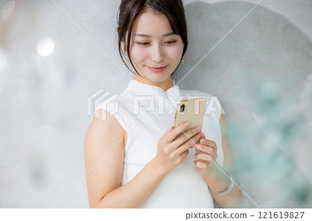A woman using a smartphone A woman using a smartphone 121619827