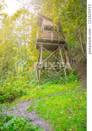 The guard tower stands tall in the labor camp Svornost, surrounded by lush greenery in Jachymov, Czechia. It serves as a historic remnant of the camp's past. 121620453