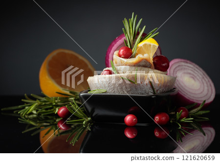 Herring fillet in oil with lemon, onion, rosemary, and cranberries. Herring fillet in oil with lemon, onion, rosemary, and cranberries. 121620659
