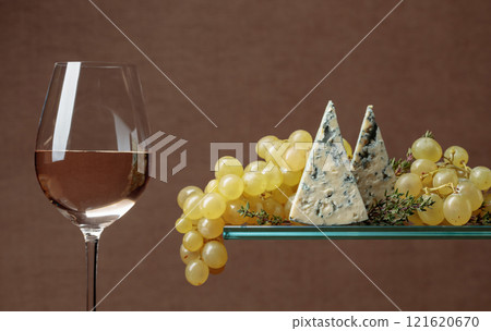Glass of white wine with snacks. Grapes with blue cheese and thyme. Glass of white wine with snacks. Grapes with blue cheese and thyme. 121620670
