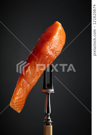 Smocked salmon on a black background. Smocked salmon on a black background. 121620674