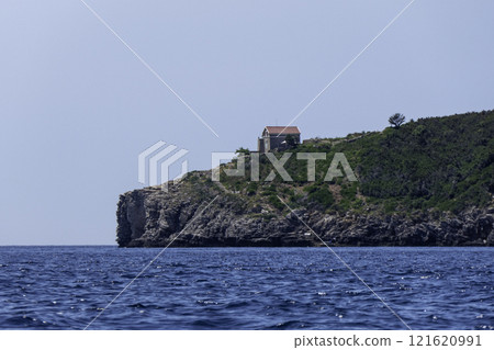 Montenegro, Budva, Sveti Nikola Island with building of small lighthouse on the Adriatic Sea 121620991