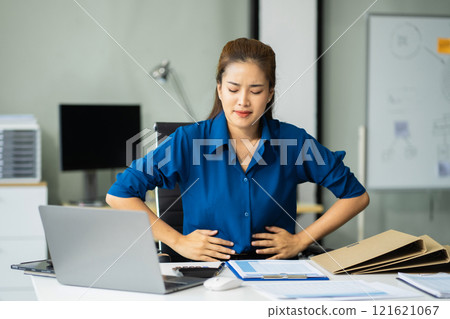 Female businessman is doing a stretchy posture due to sitting in the office for too long, office syndrome concept. Female businessman is doing a stretchy posture due to sitting in the office for too long, office syndrome concept. 121621067