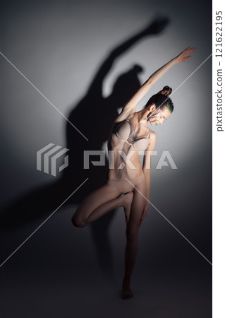 pretty sporty female doing stretching yoga exercises indoors pretty sporty female doing stretching yoga exercises indoors 121622195