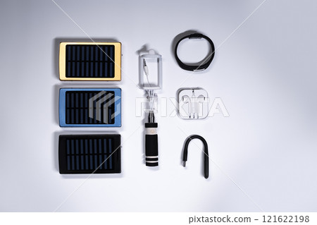 mobile power banks with solar panel set with portable electronic devices on white background isolated 121622198