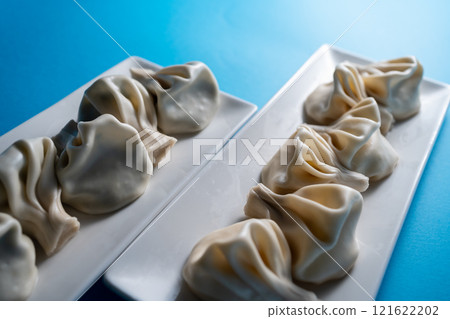 traditional georgian khinkali dumplings with cheese or meat on blue background 121622202