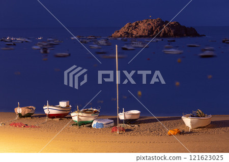 Fishing boats on the beach at night in Tossa de Mar, Spain Fishing boats on the beach at night in Tossa de Mar, Spain 121623025