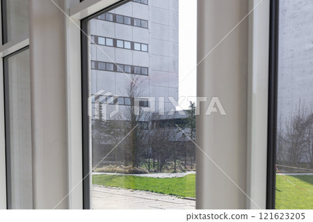 Large window closeup overlooking a modern building 121623205
