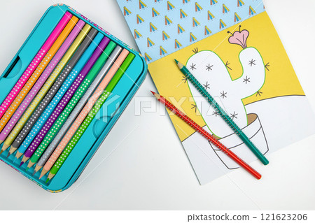 Colored pencils for drawing various colors and coloring book for children. 121623206