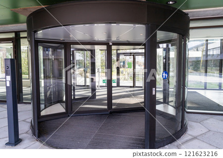 Modern entrance with revolving door. Entrance to a building. Modern entrance with revolving door. Entrance to a building. 121623216