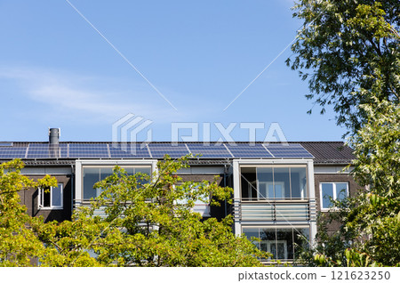 Residential building with new roof and solar panels. 121623250