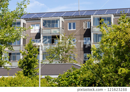 Residential building with new roof and solar panels. 121623288