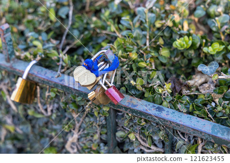 Colorful padlocks on a fence symbolize love and unity, evoking deep feelings in couples 121623455