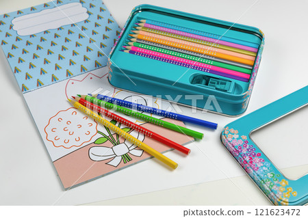 Colored pencils for drawing various colors and coloring book for children. Colored pencils for drawing various colors and coloring book for children. 121623472