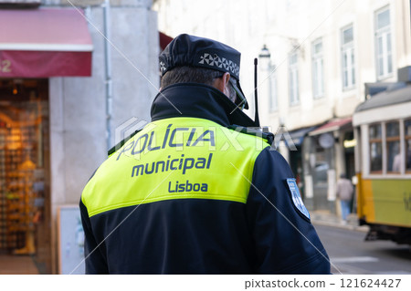 Lisbon, Portugal - December 11, 2024: Back turned Municipal Police of Lisbon officer 121624427