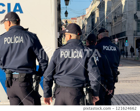Lisbon, Portugal - December 11, 2024: Back turned Portuguese policemen on patrol walking in the downtown streets 121624662