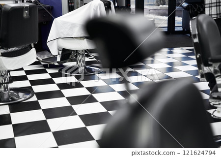 Modern barbershop interior with black and white checkered floor 121624794