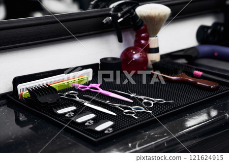 Tools and equipment arranged neatly at a barbershop station near closing time 121624915