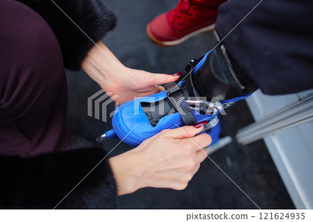 Preparing roller skates for a fun outdoor activity at a park in autumn Preparing roller skates for a fun outdoor activity at a park in autumn 121624935