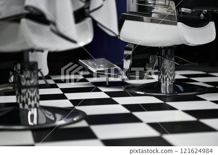 Stylish barbershop interior with modern design elements and checkered flooring 121624984
