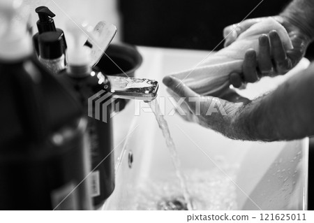 Washing hands with soap in a sink while preparing food in a kitchen Washing hands with soap in a sink while preparing food in a kitchen 121625011