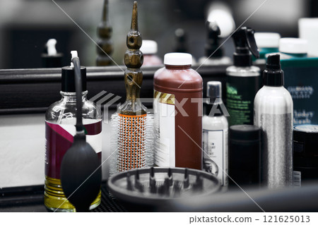 Collection of hair styling and grooming products in a salon countertop Collection of hair styling and grooming products in a salon countertop 121625013