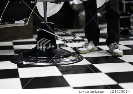 Modern barber shop interior with black and white checkerboard flooring 121625014