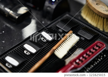 Barber tools arranged neatly on a counter during a grooming session Barber tools arranged neatly on a counter during a grooming session 121625015