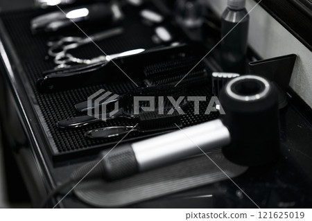 Tools arranged neatly on a salon counter ready for hairstyling services 121625019