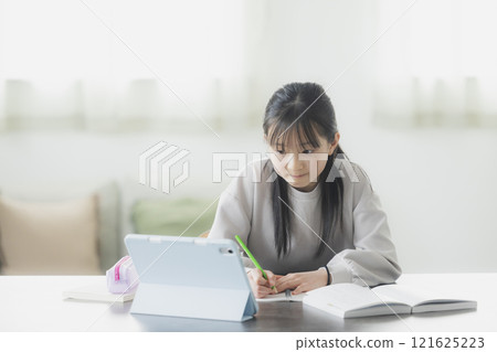 Elementary school students learning on tablets 121625223