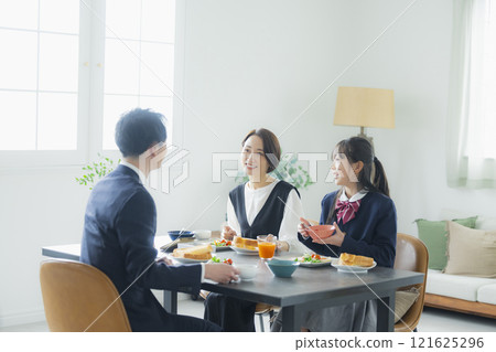 Image of a family having breakfast at the dinner table Image of a family having breakfast at the dinner table 121625296