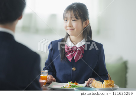 Image of a family having breakfast at the dinner table Image of a family having breakfast at the dinner table 121625299