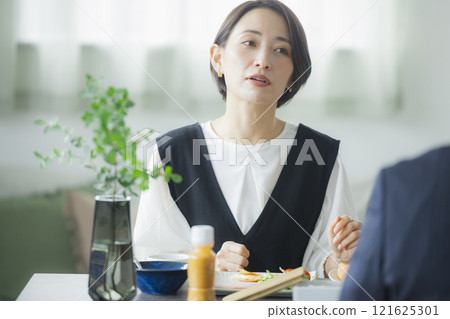 Image of a family having breakfast at the dinner table Image of a family having breakfast at the dinner table 121625301