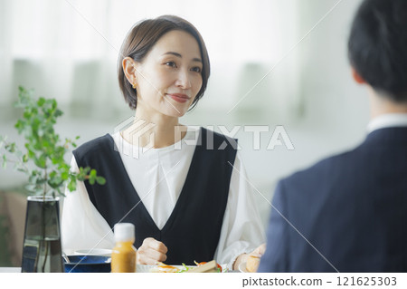 Image of a family having breakfast at the dinner table Image of a family having breakfast at the dinner table 121625303