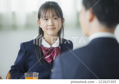 Image of a family having breakfast at the dinner table Image of a family having breakfast at the dinner table 121625305